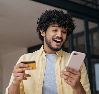 A smiling woman using a laptop.