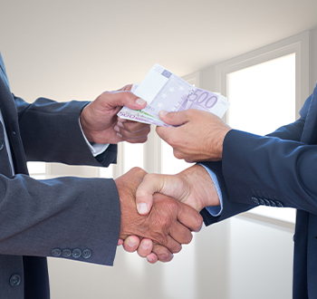 Two people shaking hands over a business deal.